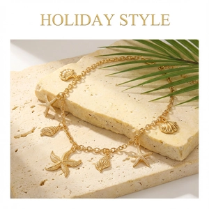 Detailed view of gold starfish and seashell charms on a necklace for holiday beach wear