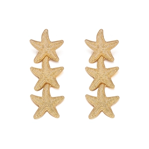 Retro golden triple starfish drop earrings with textured finish on a white background