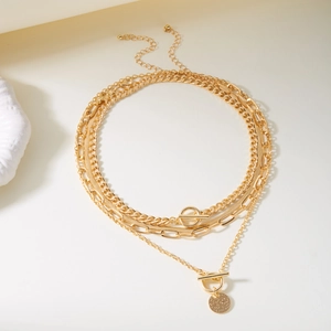 Layered gold chain necklace set featuring OT buckle and vintage coin pendant