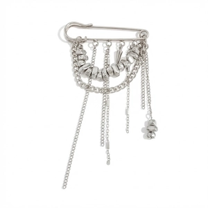 Close-up of silver metal pin brooch with multi-layered tassel chains and punk rivet details