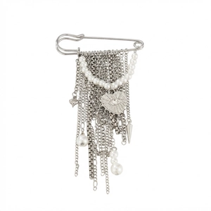 Detail of silver pin brooch with hanging chains, pearl strand, and heart-shaped eye charm