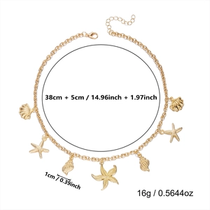 Macro view of gold starfish and seashell alloy pendants with lobster clasp detail