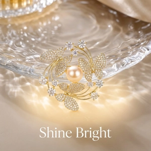 Close-up of golden butterfly brooch with champagne pearl and sparkling crystals