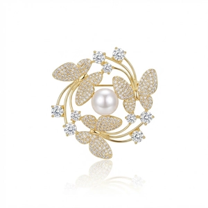Elegant gold butterfly brooch with shimmering pearls and micro-paved rhinestones