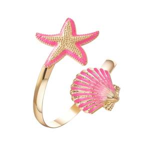 Detail of a gold adjustable ring featuring pink enamel starfish and seashell charms
