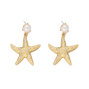 Detail view of golden starfish earrings featuring white pearls and sparkling crystal stones