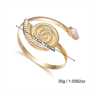 Detailed gold spiral shell armlet with white pearl inlay, 7.5cm width and 30g weight