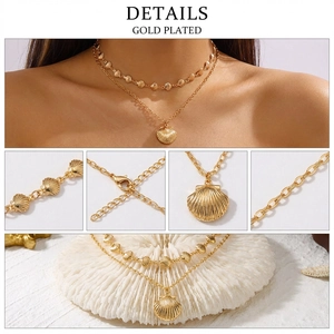Detail shot of gold plated double-layer necklace with shell and scallop pendants
