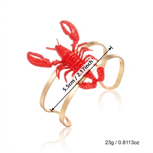 Detail of red lobster bracelet with 5.5cm width and 23g weight on white background