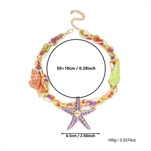 Detail of bohemian gold chain necklace with purple starfish pendant and colorful shell beads