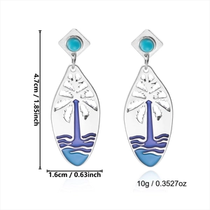Detail view of silver drop earrings with tropical enamel palm pattern and turquoise stone