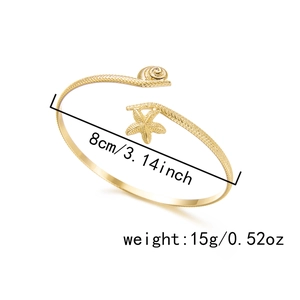 Detailed size view of golden bohemian arm cuff with starfish and shell textures