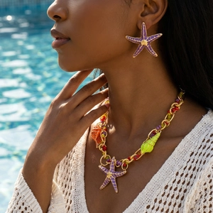 Bohemian jewelry set with starfish earrings and colorful conch necklace on a summer model