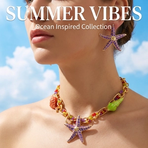 Detail of colorful starfish necklace and shell earrings on model with summer vibes