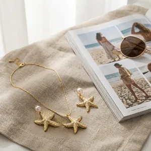 Detailed view of starfish jewelry set with pearls and zircons on a textured linen background