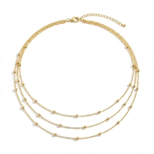 Detailansicht der dreilagigen Goldkette mit kleinen runden Perlen und Karabinerverschluss
