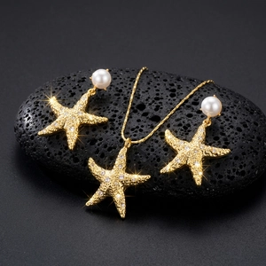 Detail of starfish jewelry set with pearls and rhinestones on volcanic rock