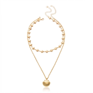 Detail of double-layer gold necklace with scallop shell pendants and seashell beads
