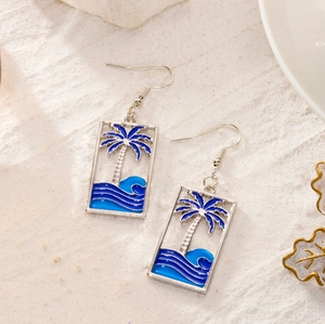 Detail of rectangular drop earrings with palm tree and ocean wave enamel design