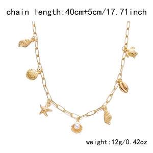 Detailed close-up of golden ocean-themed necklace with starfish, shell, and turtle charms