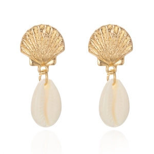 Macro detail of starfish earrings with golden scallops and white shell pendants