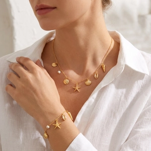 Bohemian gold ocean jewelry set with starfish pendants, shell charms and white beads