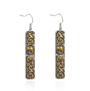 Detail of silver earrings with gold elephant relief and ethnic floral motifs