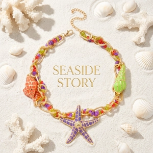 Detail of colorful seaside necklace with starfish and shell pendants on white sand