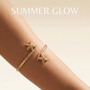 Detailed close-up of golden starfish arm cuff with textured finish on female model