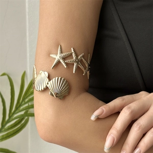 Bohemian gold upper arm cuff bracelet featuring starfish and seashell marine charms
