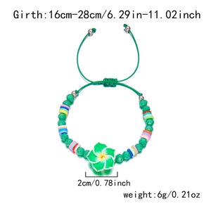 Detail view of handmade bohemian bracelet with green flower charm and beads