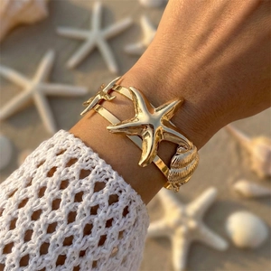 Bohemian gold bangle with starfish and shell accents for beach vacations