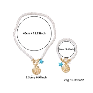 Detail of beach jewelry set with pearls, golden shell pendants and blue starfish charms