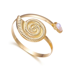 Bohemian gold open arm cuff with spiral nautilus shell and baroque pearl accent