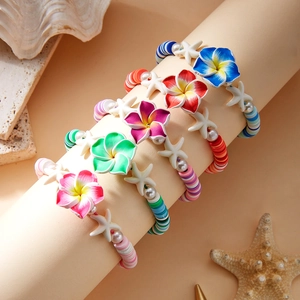 Detail view of five bohemian plumeria flower and starfish beaded bracelets on a display