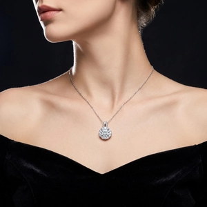 Elegant woman wearing a sparkling round diamond pendant necklace on a silver cross chain