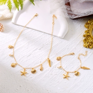 Close-up of golden starfish and seashell pendants on bohemian beach jewelry set