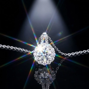 Macro shot of halo silver necklace with brilliant round cut stone and sparkling fire