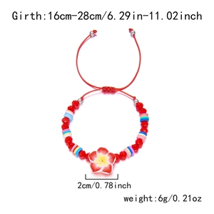 Detail of red adjustable woven bracelet with plumeria flower and colorful heishi beads