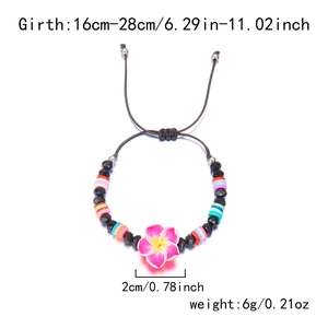 Detail view of handmade adjustable bracelet with pink flower pendant and colorful clay beads