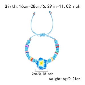 Detail of adjustable beaded bracelet with blue plumeria flower and polymer clay beads
