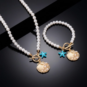 Bohemian pearl jewelry set featuring golden seashell and blue starfish charms with OT buckle