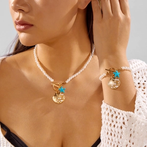 Bohemian seashell and starfish jewelry set with pearls and turquoise beads worn by a model