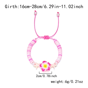 Detail of adjustable beaded bracelet with pink plumeria flower and starfish charms