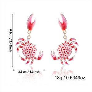 Detail view of red crab enamel earrings with gold metal base and dimensions marked