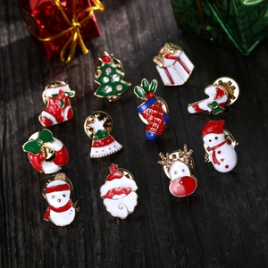 Christmas enamel brooch set featuring tree, Santa, and reindeer icons on wood
