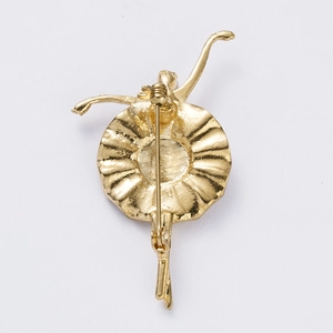 Detail view of the secure pin closure and golden metallic texture on the brooch back
