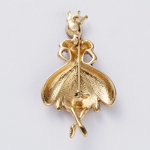 Detailed back view of golden ballerina brooch showing metal pin and safety clasp texture