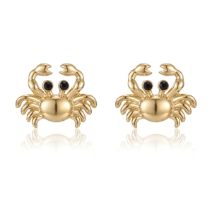 Macro detail of golden crab stud earrings with shiny finish and black stone eyes