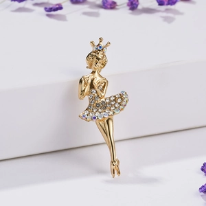 Elegant gold ballerina brooch with sparkling crystals on a clean white display stand
